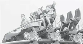  ?? JOE BURBANK/ORLANDO SENTINEL ?? SeaWorld Orlando guests wearing masks ride the Mako roller coaster on June 11.