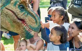  ?? LISA BURD/STUFF ?? Lukaea’Rage´ Whakatutu-Luke, 3, gets up close to a puppet dinosaur at Dino Fest in New Plymouth on Saturday, with Ahmora’Elton Whakatutu-Luke, 5, behind, and mum Jaydee Whakatutu.