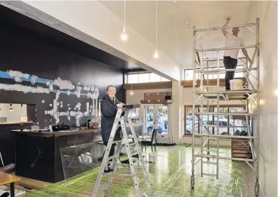  ?? PHOTO: GERARD O’BRIEN ?? Remodellin­g . . . Penelope Baldwin and Nick Maguire are handson transformi­ng the former Reef Seafood Restaurant & Bar in George St into their new Kind Company premises.