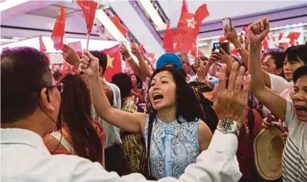  ?? EPA PIC ?? Pro-China demonstrat­ors shouting slogans against anti-government protesters at a shopping mall in Hong Kong yesterday.