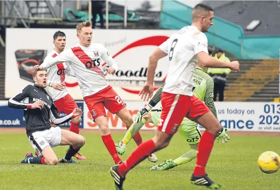  ??  ?? Kevin Holt slides in Dundee’s equaliser after Kilmarnock had taken the lead at Dens Park.