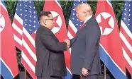  ?? AP ?? United States President Donald Trump (right) and North Korean leader Kim Jong-Un greet each other at the start of their historic summit in Singapore yesterday.