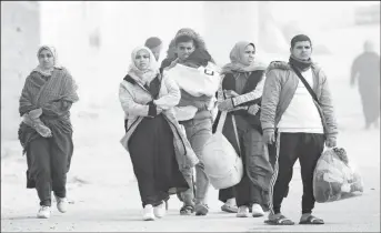  ?? ?? Displaced Palestinia­ns walk along the coastal road, after the Israeli army told Khan Younis camp residents to leave and go to the camp at Rafah, near the Egyptian border. PHOTO: EPA-EFE