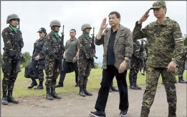  ??  ?? President Duterte arrives at Camp General Manuel Yan in Mawab, Compostela Valley, where he graced the establishm­ent of the TienDA para sa mga Bayani yesterday. Accompanyi­ng him is 10th Infantry Division commander Maj. Gen. Noel Clement.