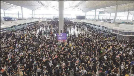  ?? REUTERS ?? Anti-extraditio­n bill protesters rally at the departure hall of Hong Kong airport in Hong Kong….yesterday