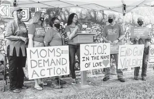  ??  ?? Cori Ferraro with Moms Demand Action for Gun Sense in America speaks at the rally. Standing with her are Wilson, from left, Gail Reinhart, Castillo, Mike Munroe and Pauline Howard.
