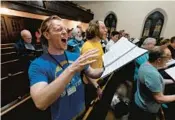  ?? KENNETH K. LAM/STAFF ?? Harry Munroe, left, sings with the Patterson Park Community Chorus, which is open to all levels of singers.
