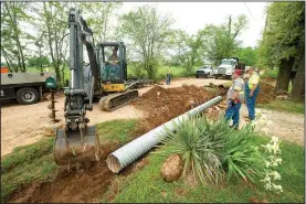  ?? NWA Democrat-Gazette/BEN GOFF • @NWABENGOFF ?? A crew from the Benton County Road Department replaces drainage culverts May 10 along Accident Road near Springdale.