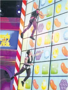  ?? SONJA FLEMMING/CBS ?? Former Big Brother contestant­s Frankie Grande and Caleb Reynolds compete in the new game show, Candy Crush.