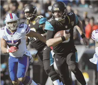  ?? AP PHOTO ?? OFF TO THE RACES: Quarterbac­k Blake Bortles rips off a big gain during the Jaguars’ playoff win over the Bills yesterday in Jacksonvil­le, Fla.