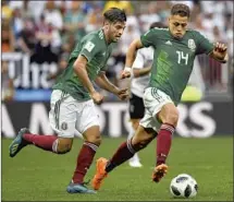  ?? Yuri Cortez AFP/Getty Images ?? AS TEAMMATES, Vela, left, and Hernández led a formidable attack for Mexico during the 2018 FIFA World Cup in Russia.