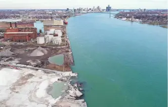  ?? JUNFU HAN AND ERIC SEALS/ DETROIT FREE PRESS ?? On Nov. 27, the site known as the Detroit Dock collapsed into the Detroit River under the weight of large aggregate piles. The ground was at one time contaminat­ed with uranium and other dangerous chemicals.