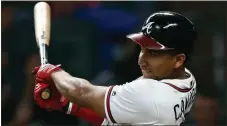  ?? John Bazemore / The Associated Press ?? Atlanta’s Johan Camargo drives in a run with a base hit during the fourth inning of Thursday’s game against the Washington Nationals.