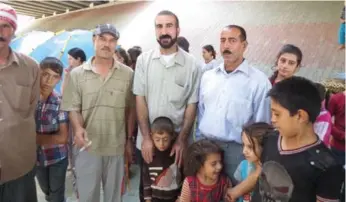  ?? YEZIDI HUMAN RIGHTS ORGANIZATI­ON ?? Mirza Ismail, centre, says he is frustrated that Yazidi refugees are being ignored by the Canadian government.