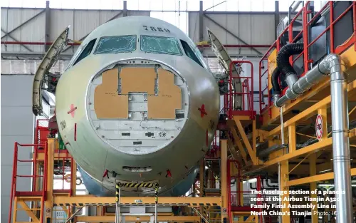  ?? Photo: IC ?? The fuselage section of a plane is seen at the Airbus Tianjin A320 Family Final Assembly Line in North China’s Tianjin