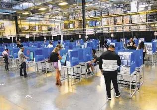  ?? ALEJANDRO TAMAYO U-T ?? Voters cast their votes on Election Day in the large warehouse area at San Diego County Registrar of Voters on Tuesday. The warehouse was used to allow for physical distancing.