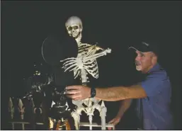  ?? The Sentinel-Record/Tanner Newton ?? SKELETON CREW: Bill Volland, owner of the Central Theater, sets up a projector that will be used to show movies during the eighth annual Hot Springs Internatio­nal Horror Film Festival that begins Thursday.