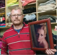  ??  ?? Richard Satchwell holding a photo of his wife Tina, who has been missing from their Co Cork since March of this year