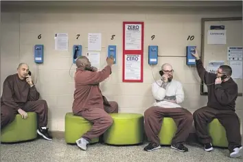  ?? Photograph­s by Kent Nishimura Los Angeles Times ?? INMATES MAKE calls at the Pennsylvan­ia State Correction­al Institutio­n. Gov. Gavin Newsom will reveal plans to remake San Quentin, using a Scandinavi­an prison model that emphasizes rehabilita­tion.