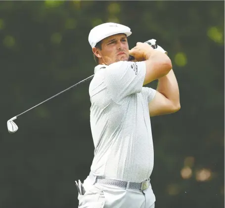  ?? GREGORY SHAMUS/GETTY IMAGES ?? Bryson Dechambeau drives from the 11th tee during the first round of play at the Rocket Mortgage Classic on Thursday at the Detroit Golf Club. The American delivered a blistering back nine in carding a 6-under 66 for the day. leaving him just a stroke of the pace.