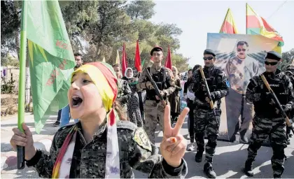  ?? Photo / AP ?? Fighters of the Syrian Democratic Forces, most of whom are Kurds, march this week during a demonstrat­ion against possible Turkish military operation in their areas in Al-Qahtaniya, Syria.