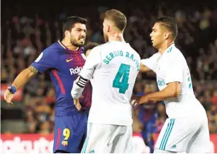  ??  ?? Luis Suarez of FC Barcelona (L) squares up with Real Madrid captain, Sergio Ramos in a past El Clasico match