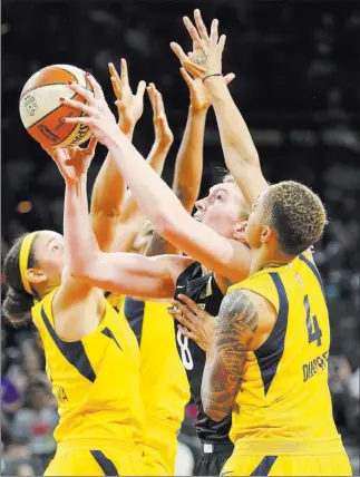  ?? Richard Brian ?? Las Vegas Review-journal @vegasphoto­graph Las Vegas Aces center Carolyn Swords (8) goes up for a shot Sunday as she is swarmed by Indiana Fever defenders at Mandalay Bay Events Center. She had 12 points and 10 rebounds.
