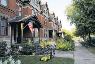  ?? JOSE M. OSORIO/CHICAGO TRIBUNE ?? Mike Shymanski, 78, mows the lawn outside of his home in Chicago’s Pullman neighborho­od on Tuesday. Shymanski says he has lived in Pullman for 54 years.