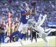  ?? Dustin Satloff / Getty Images ?? The Giants’ Evan Engram scores a touchdown while defended by the Raiders’ Johnathan Abram on Sunday.