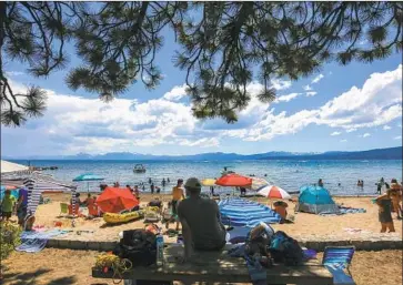  ?? Los Angeles Times ?? SUNBATHERS and swimmers line Kings Beach on Lake Tahoe in 2017. Although people have been frolicking in the buff along certain shores of the lake for years, it’s still illegal, Carson City Sheriff Ken Furlong said.