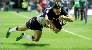  ?? PHOTO: PHOTOSPORT ?? Codie Taylor dives over to score in the corner as the All Blacks hung on for an unconvinci­ng win over Scotland.