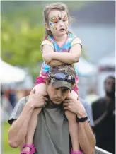  ??  ?? Charlotte Wagner, 3, of Walnutport, hitches a ride on the shoulders of her father, Dustin.