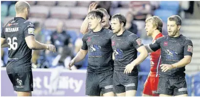  ??  ?? Widnes celebrate Matt Whitley’s second try of the game against Salford.