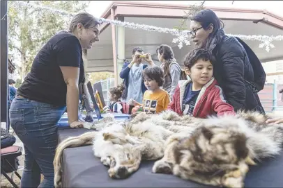  ?? Chris Torres/ The Signal ?? Maggie Romero, an education program coordinato­r with the William S. Hart Museum, teaches event attendees about nature and wildlife in the area at the Barnyard Lights Tour at William S. Hart Regional Park in Newhall on Saturday.