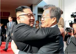  ?? AP ?? North Korean leader Kim Jong Un, left, and South Korean President Moon Jae-in embrace each other after their meeting at the northern side of the Panmunjom in North Korea.