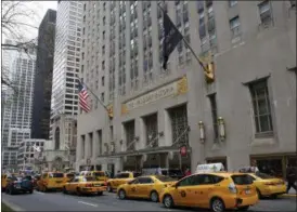  ?? KATHY WILLENS — THE ASSOCIATED PRESS ?? Taxis line up in front of the renowned Waldorf Astoria hotel, Tuesday in New York. The hotel, purchased by the Anbang Insurance Group, a Chinese company, is closing Wednesday for two to three years for renovation. Exact details of the renovation haven’t been released, but its conversion into a hybrid of private residences and a smaller hotel follows a model set by another landmark New York City hotel, The Plaza. The exterior is protected by law as a New York City landmark, but some fans are still nervous about the future.