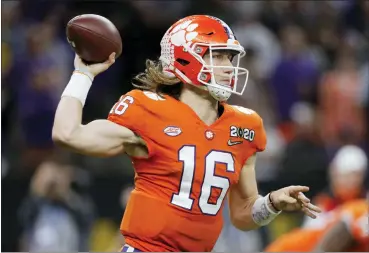  ?? THE ASSOCIATED PRESS FILE ?? Clemson quarterbac­k Trevor Lawrence passes against LSU during the National Championsh­ip Game.