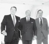  ?? BARRY THUMMA/AP 1985 ?? Secretary of State George Shultz, center, walks into the White House with President Ronald Reagan and Vice President George H.W. Bush.