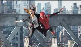  ?? Matt Kennedy/Sony Pictures / TNS ?? MJ, played by Zendaya, and Spider-Man, featuring Tom Holland in the famous red suit, jump off a bridge in “Spider-Man: No Way Home.”