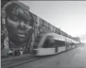  ?? MARIO TAMA, GETTY IMAGES ?? A VLT train passes in the revitalize­d port district that has been heralded by organizers as one of Rio’s Olympic legacy successes.