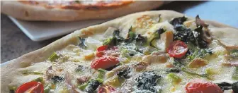  ?? STAFF PHOTO BY ANGELA ROWLINGS ?? SLICE OF HEAVEN: Broccoli rabe porcini pizza is among the specialtie­s at Casa Mia Cucina Italiana in Marblehead.