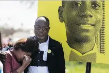  ?? ALLEN McINNIS FILES ?? Akouena Noella Bibie is comforted by her husband, Kouadio Frederic Kouakou, in front of a poster for their missing son, Ariel Kouakou, who was last seen on March 12.