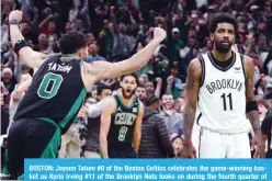  ?? ?? BOSTON: Jayson Tatum #0 of the Boston Celtics celebrates the game-winning basket as Kyrie Irving #11 of the Brooklyn Nets looks on during the fourth quarter of Round 1 Game 1 of the 2022 NBA Eastern Conference Playoffs at TD Garden on April 17, 2022. —AFP