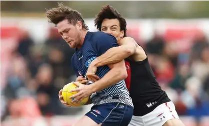  ??  ?? Jack Steven of Geelong is tackled by Dylan Shiel of Essendon during the Marsh Community Cup AFL match in March of this year. Police are investigat­ing after Steven was hospitalis­ed in Melbourne. Photograph: Daniel Pockett/Getty Images