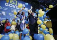  ?? AP PHOTO/NAM Y. HUH ?? Democratic gubernator­ial candidate J.B. Pritzker, right, and his running mate Lt. Governor candidate Juliana Stratton celebrate as they wave to supporters after they won over Republican incumbent Bruce Rauner in Chicago.