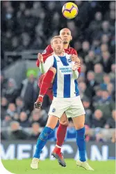  ??  ?? Brighton’s Murray holds off Fabinho