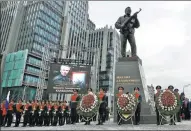  ?? SERGEI KARPUKHIN / REUTERS ?? Guards of honor stand next to a monument to Mikhail Kalashniko­v, the designer of the AK-47 assault rifle, during its opening ceremony in Moscow on Tuesday.