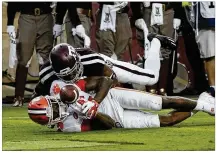  ?? BOB LEVEY / GETTY IMAGES ?? Tee Higgins of Clemson scores after a 64-yard reception in the second quarter of their game Saturday as Charles Oliver of Texas A&amp;M is unable to stop him.