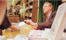  ?? ANDERS KRUSBERG/ASSOCIATED PRESS ?? In this Aug. 21, 1995 file photo, Winston Groom, author of “Forrest Gump,” the book on which the film was based, signs copies of “Gump & Co.,” the sequel to “Forrest Gump” at a New York City bookstore.