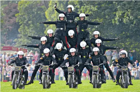  ??  ?? White Helmets riders from the Royal Signals performing one of their signature routines at the Chatsworth Country Fair at Chatsworth House near Bakewell, Derbyshire